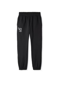 Zwarte joggers met een elastische tailleband en enkels, met de witte tekst "Women of the Wave" op het linkerpijp. Zachte stoftextuur.
