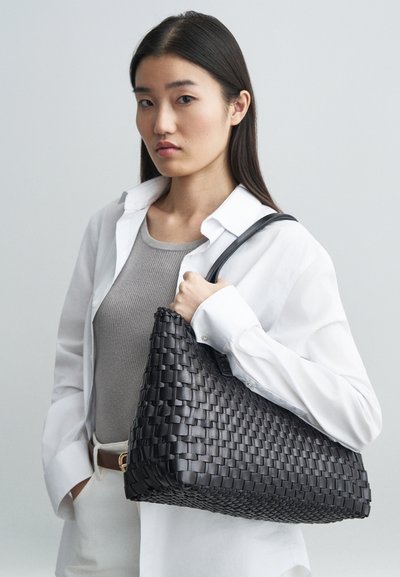 Black woven handbag with a smooth texture, curved top, and a single shoulder strap. Features a subtle sheen and structured shape.