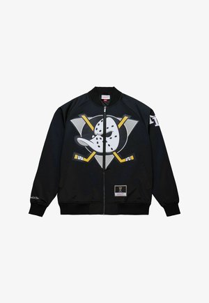 Black bomber jacket featuring a prominent graphic of a duck with a hockey stick, yellow accents, and a branding patch on the lower hem.