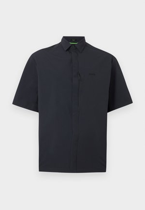 Camisa negra de manga corta abotonada con tapeta oculta en la parte delantera y cuello puntiagudo, mostrada sobre un fondo blanco.