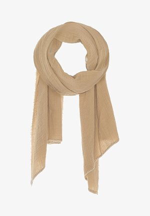 Lekki beżowy szalik wykonany z teksturowanej tkaniny, charakteryzujący się miękkim, pomarszczonym wyglądem i postrzepionymi brzegami dla swobodnego stylu.