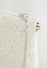 Sparkling white clutch with a pattern of iridescent rhinestones, silver hardware, and a braided chain strap, featuring a clasp closure.