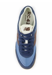 Blue and brown athletic shoe with a suede and mesh upper, lace closure, and a rubber sole. Retro design with contrasting color accents.