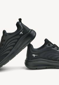 Black athletic shoes with a textured mesh upper, sleek design, laces, and a smooth rubber sole. Features a subtle logo on the side.