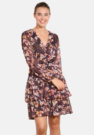 Floral dress with a deep V-neck, long sleeves, and tiered ruffle hem. Features dark purple fabric with multicolored floral pattern and sheer texture.