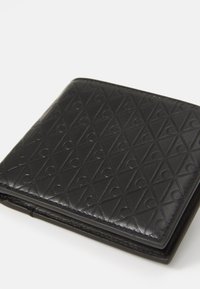 Portefeuille en cuir noir avec un motif en diamant en relief et des accents courbés. Forme carrée et texture lisse, avec des bords soigneusement cousus.