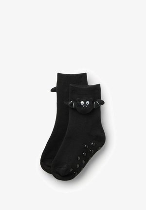 Calze alla caviglia nere con un morbido design di pipistrello nero sul risvolto, dotate di punti in gomma sulla suola per una maggiore aderenza.