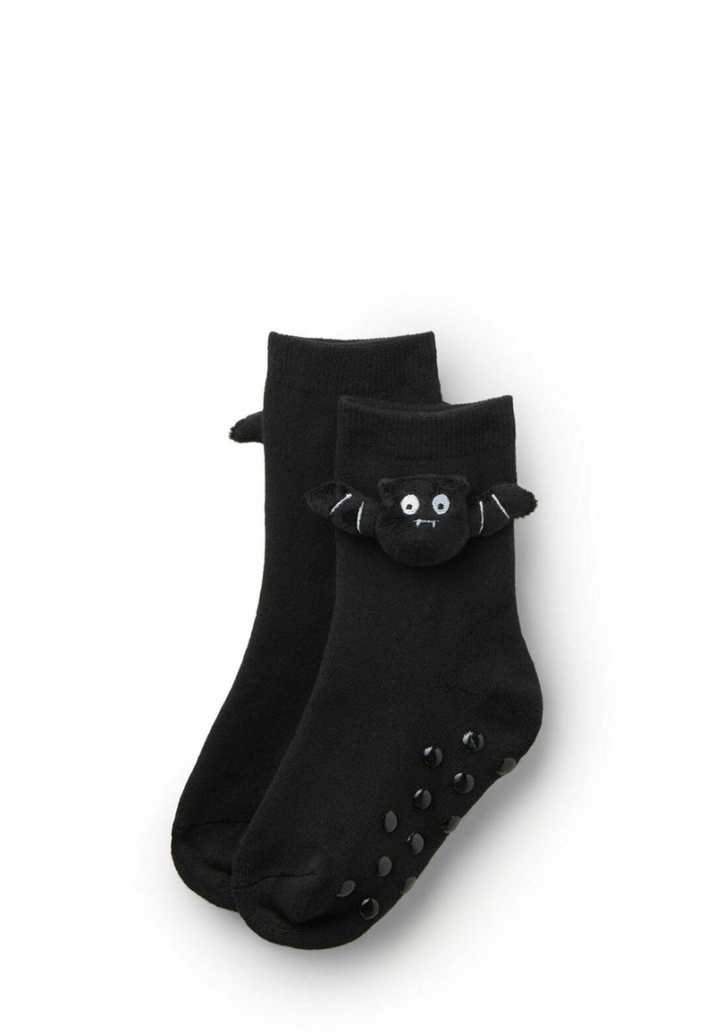 Czarne skarpetki do kostek z miękkim czarnym wzorem nietoperza na mankiecie, z gumowymi kropkami na podeszwie dla lepszej przyczepności.