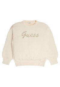 Kremowy sweter z długimi rękawami, ściągaczowymi mankietami i dołem. Ozdobiony logo „Guess” wysadzanym kolorowymi kryształkami.