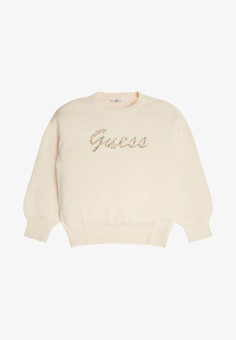 Kremowy sweter z długimi rękawami, ściągaczowymi mankietami i dołem. Ozdobiony logo „Guess” wysadzanym kolorowymi kryształkami.