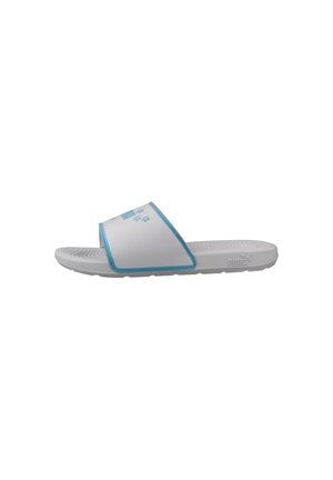 White and blue slide sandal with textured sole and wide strap featuring light blue floral design and Puma logo on the side.