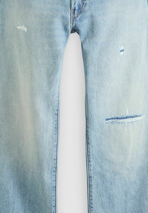 Light blue denim jeans with faded wash and three small distressed rips on the front thighs.