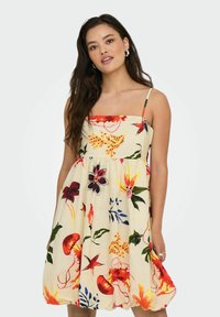 Robe sans manches à imprimé floral avec un décollet�é carré. Dotée d'un tissu beige clair, de motifs floraux multicolores vibrants et d'une jupe évasée.