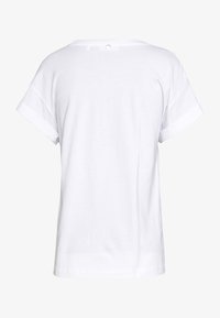 White short-sleeve t-shirt with rolled cuffs and a small back button detail. Made of smooth, lightweight fabric. Casual fit and design.