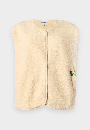 Lichtbeige mouwloze fleece vest met drukknoopjes aan de voorkant en een klein merkje op de rechterzijzak.