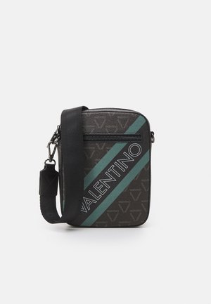 Sac bandoulière en tissu noir avec une bande diagonale teal et le logo "VALENTINO" en gras. Fermeture zippée et détail de sangle réglable.