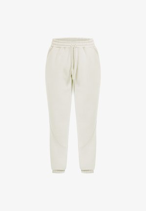 Lys beige, tapered joggers lavet af blødt stof med elastisk talje og manchetter, der har buede sømdetaljer på siderne.