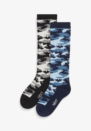 Two pairs of knee-high socks. One in gray and black camouflage; the other in blue and navy camouflage. Both feature ribbed cuffs.