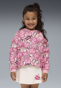 Sudadera rosa con gráficos divertidos, que incluyen personajes y texto. Tejido suave y puños acanalados, combinada con una falda rosa claro que presenta un diseño de personaje.