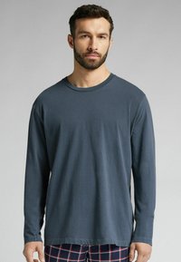 Dlouhý rukáv, heather navy tričko z měkké tkaniny s kulatým výstřihem a uvolněným střihem, s rovnými lemy a minimem švů.