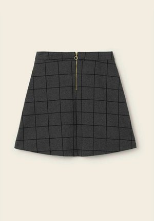 Mørkegrå A-line nederdel med sort ternet mønster og en gylden lynlås ned foran på en beige baggrund.