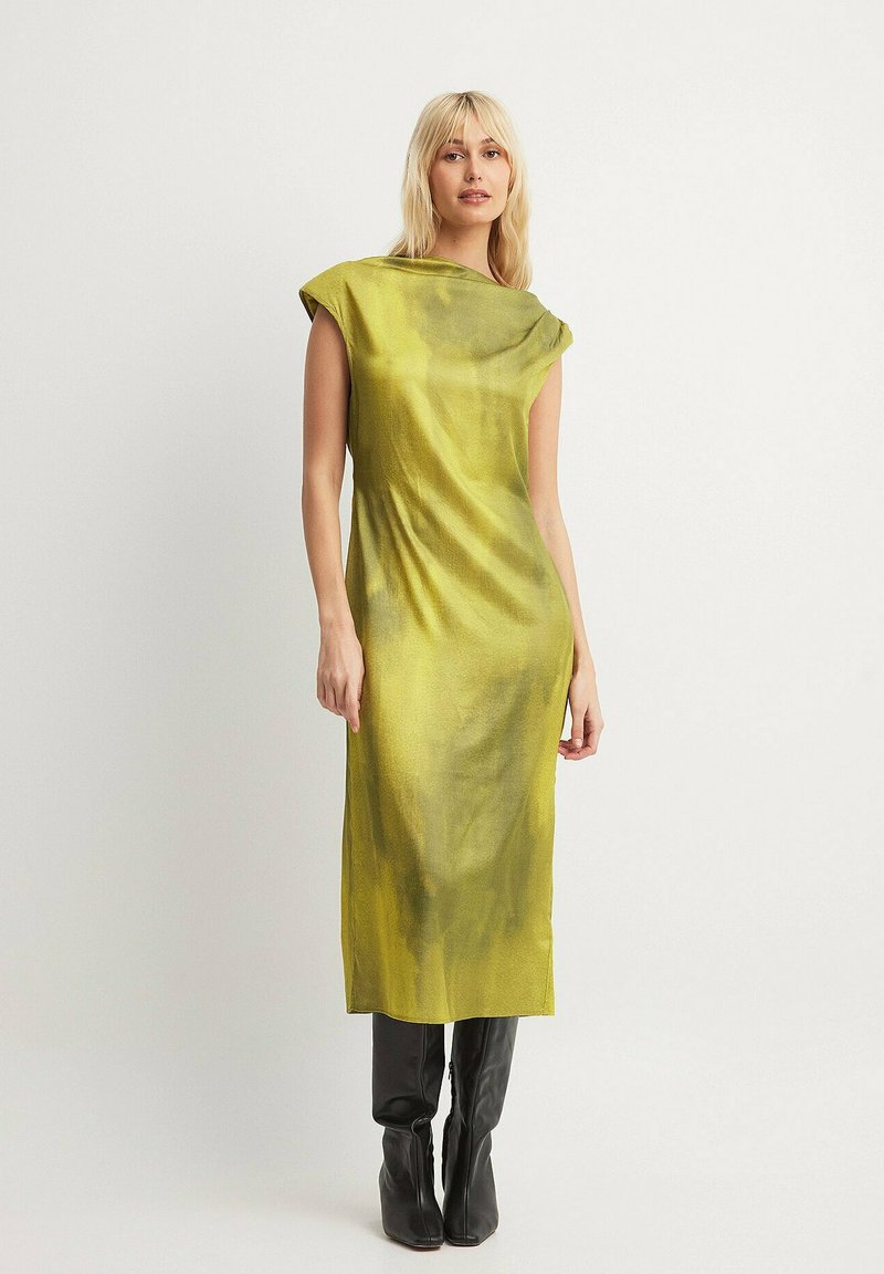 Knee-length, sleeveless dress in vibrant lime green silk with a minimalist design, featuring a boat neckline and a smooth, slightly shiny texture.