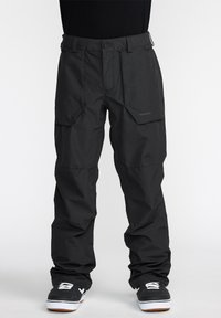 Pantalons étanches noirs avec poches cargo et coupe d�écontractée. Fabriqués en matériau durable avec des coutures renforcées et des caractéristiques de taille ajustable.