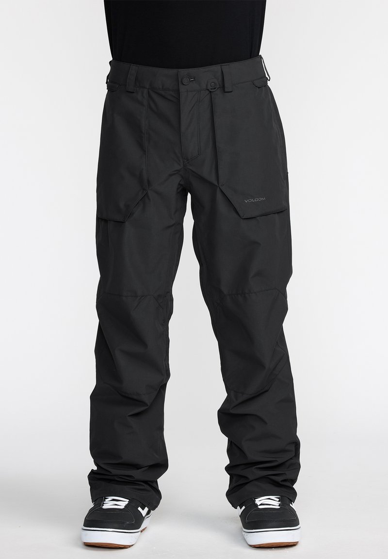 Pantalons étanches noirs avec poches cargo et coupe décontractée. Fabriqués en matériau durable avec des coutures renforcées et des caractéristiques de taille ajustable.