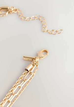 Gold chain necklace featuring interlinked chains, a lobster clasp, and a textured design. Adjustable length with a linked extension.