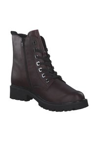 Bottines en cuir brun avec un laçage à l'avant et une fermeture éclair sur le côté. Caractéristiques d'une semelle en caoutchouc noire épaisse et d'œillets métalliques.