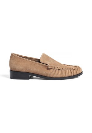 Suede loafers in tan with a rounded toe, featuring gathered detailing on the vamp and a low, rectangular black heel.