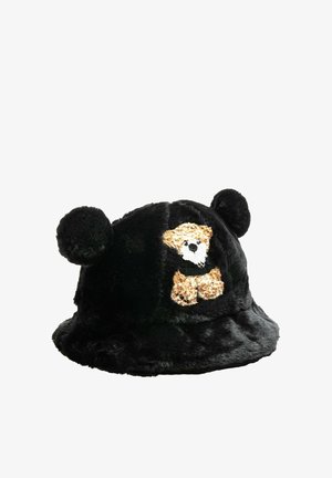 Sombrero tipo pescador de felpa negra con orejas redondas y un gráfico de oso en la parte frontal. Textura suave con ala flexible y sin herrajes visibles.