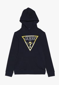 Sudadera con capucha de color azul marino hecha de material suave. Cuenta con un gran logotipo triangular en oro y negro con un signo de interrogación y un bolsillo frontal.