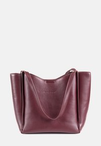Maroon leather tote bag with smooth texture, angular design, and dual shoulder straps. Features embossed logo on the front.