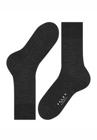 Mustat sukat, joissa on sileä, pehmeä pinta, hillitty meleerattu kuvio ja logo painettuna pohjaan. Tavallinen sukka muoto.