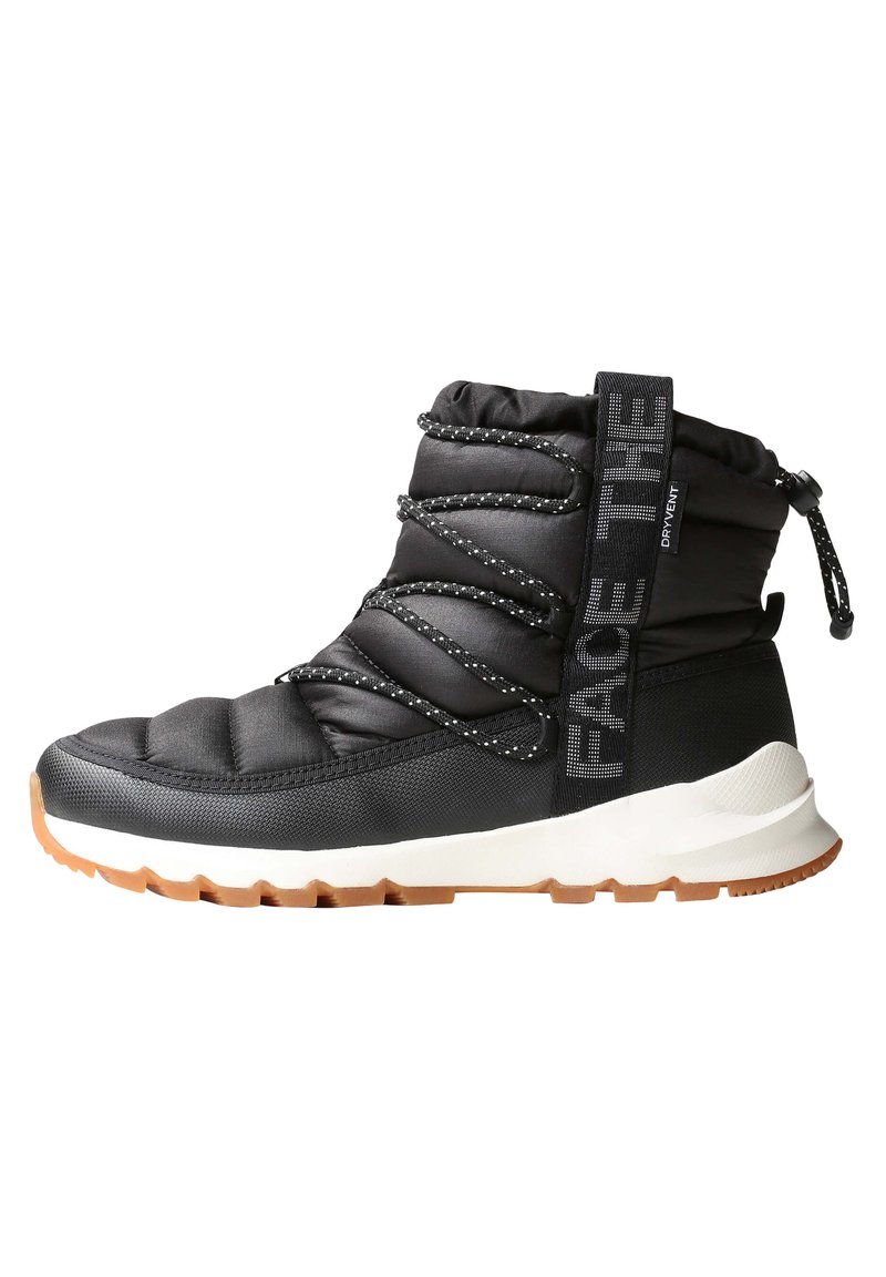 Black insulated ankle boot with quilted upper, elastic laces, a pull tab, and a white midsole atop a gum rubber outsole.