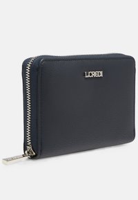 Navy blue leather wallet with a textured finish, silver-tone zipper, and an embossed brand logo on the front. Zipper pull has a decorative accent.