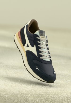 Navy blue athletic shoe with a mix of mesh and suede, featuring a white logo, light blue accents, and a multicolored sole.