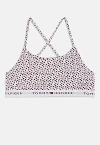 Bralette blanco con estampado floral multicolor, tirantes ajustables en forma de crisscross y una banda elástica de marca que presenta "TOMMY HILFIGER."