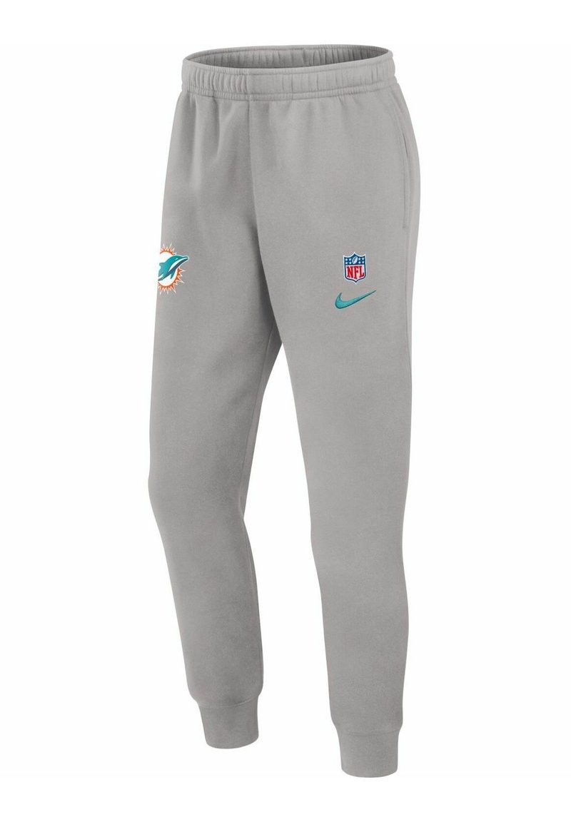 Ljusgråa träningsoveraller med elastisk midja, prydda med Miami Dolphins-logotyp, NFL-sköld och Nike-swoosh i teal. Mjuk textur och avsmalnande passform.