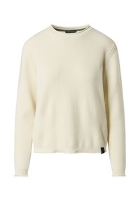 Maglione a coste crema con maniche lunghe, scollo rotondo e etichetta nera a contrasto sul lato sinistro inferiore. Dettaglio di superficie testurizzata.