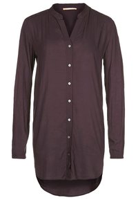 Chemisier à manches longues de couleur violet foncé pour femme, avec col mandarin et ourlet arrondi asymétrique.