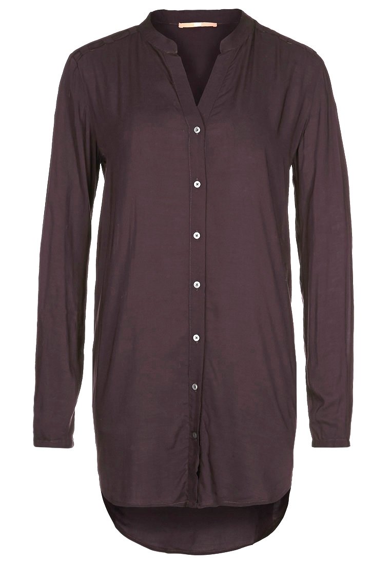 Chemisier à manches longues de couleur violet foncé pour femme, avec col mandarin et ourlet arrondi asymétrique.