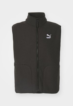 Gilet in pile nero con colletto alto, due tasche frontali e zip centrale. Presenta un logo Puma bianco sul lato sinistro del petto.