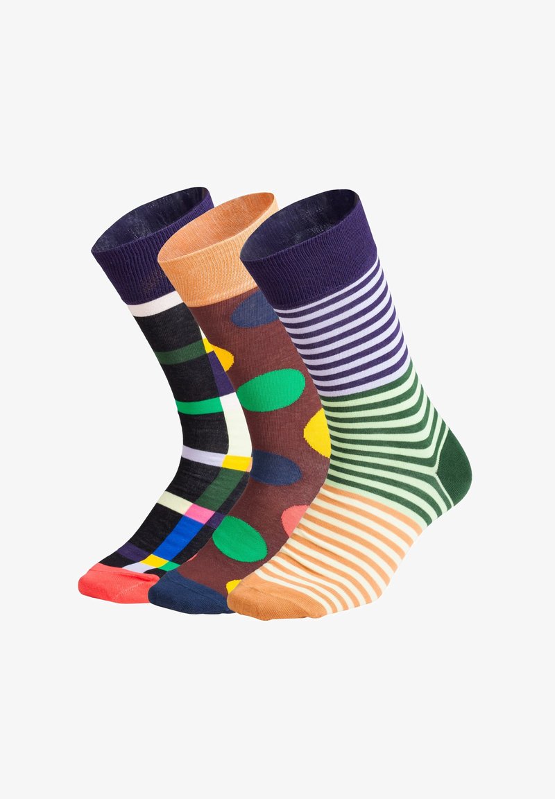Drei Paare von Crew-Socken: schwarze Karos mit Farben, braune Socken mit großen Punkten und grün-gestreifte Socken, die verschiedene Muster und strukturierte Bündchen aufweisen.