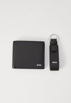 Black leather wallet with textured finish and white "BOSS" logo. Accompanied by a matching key ring with a looped strap and logo detail.