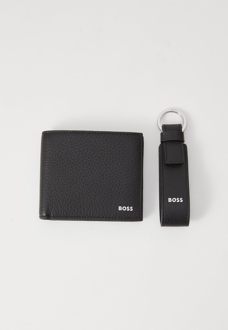 Black leather wallet with textured finish and white "BOSS" logo. Accompanied by a matching key ring with a looped strap and logo detail.