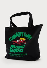 Black canvas tote bag with thick handles, featuring a colorful graphic of a cartoon fish and green text: "CARHARTT WIP PRONTO SUBITO."