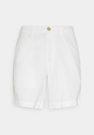 Shorts en lin blancs avec une fermeture à bouton et un devant plat. Présente des poignets retroussés et une texture légère et respirante.