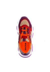 Multi-colored sneaker featuring a red upper, orange laces, purple accents, and a textured beige panel. Clear sole with purple detailing.
